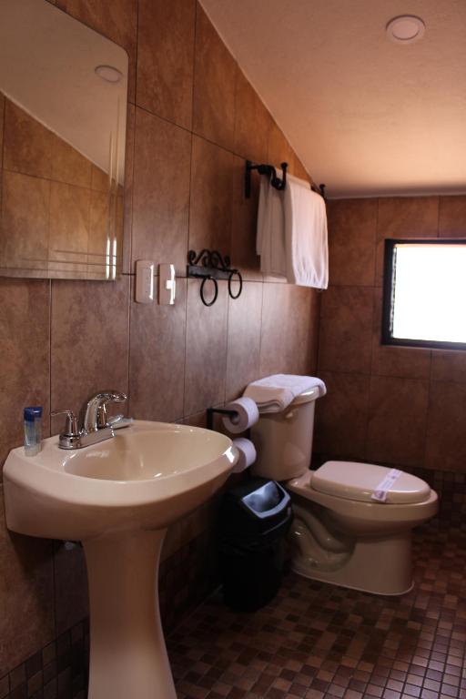 a bathroom with a sink and a toilet at Hotel Casa Margarita in San Cristóbal de Las Casas