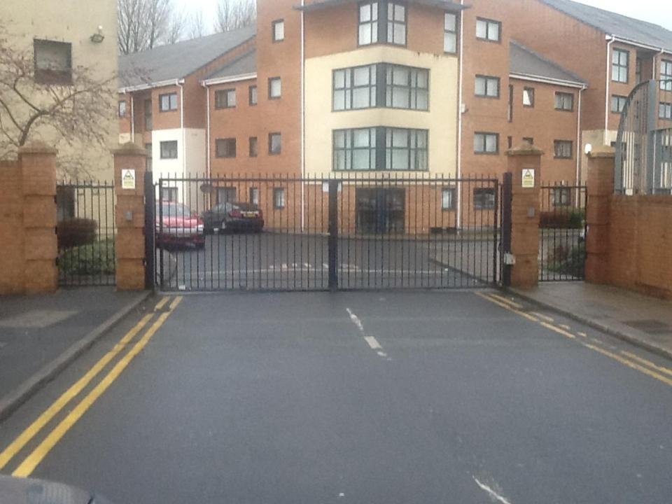 a driveway with a gate in front of a building at Liverpool 2 Bedroom Apartment in Liverpool