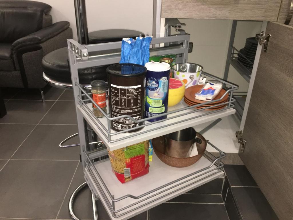 a shelf in a kitchen with food items on it at Catalans in Marseille