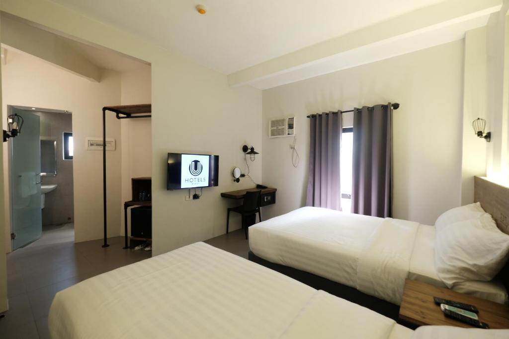 Postel nebo postele na pokoji v ubytování U Hotels Makati