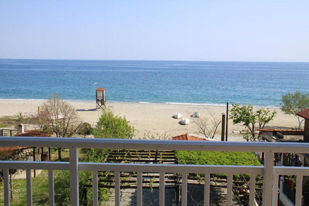 a view of a beach from a balcony at Fasoli Studios in Paralia Panteleimonos