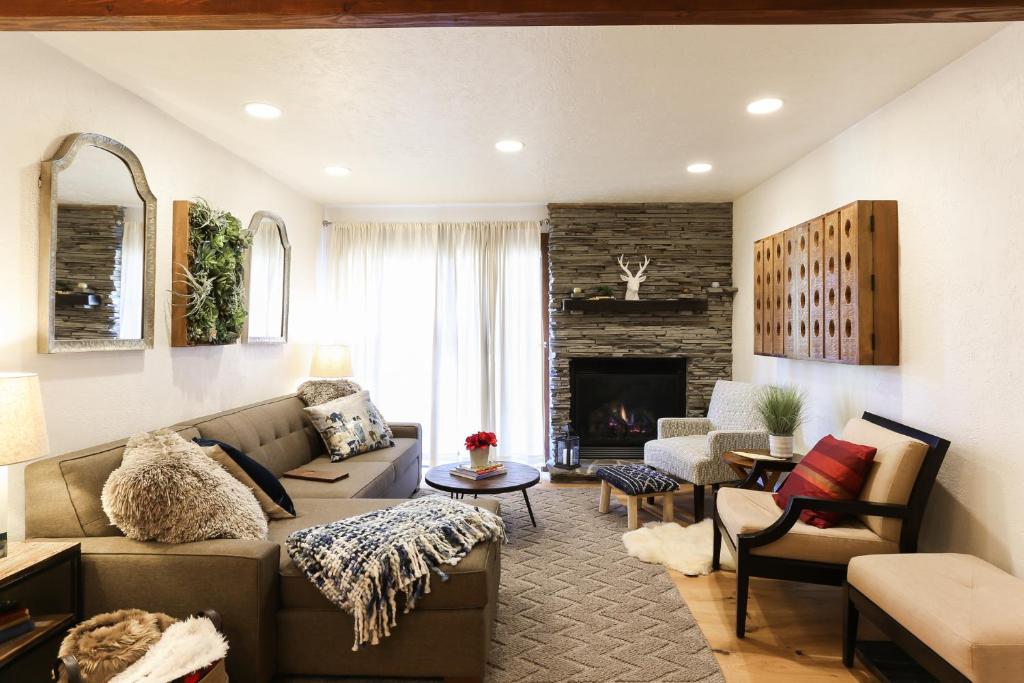 a living room with a couch and a fireplace at POW HAUS: Modern Beaver Creek 2BR w/ Ski Access in Avon