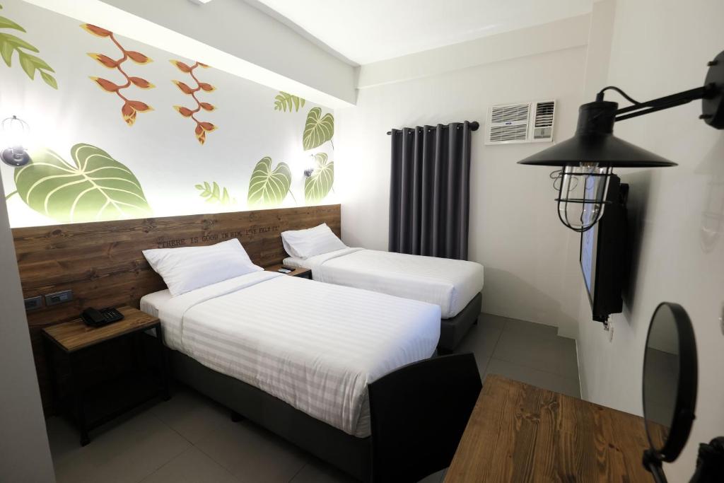 Postel nebo postele na pokoji v ubytování U Hotels Makati