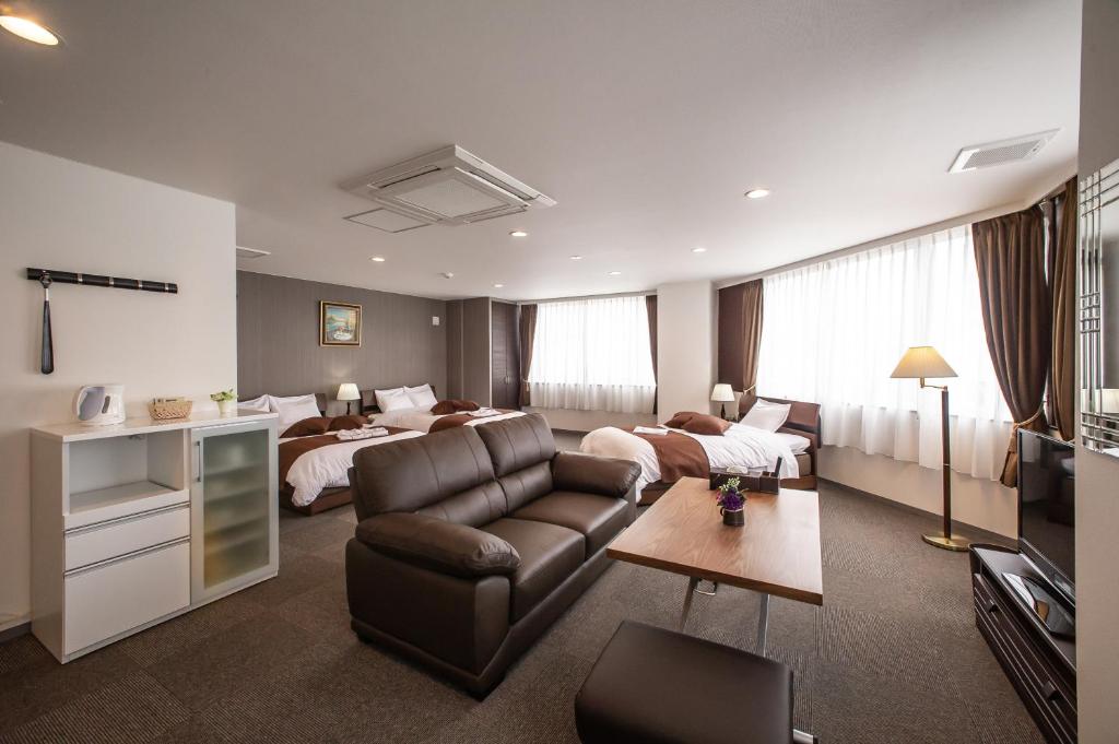a hotel room with a bed and a living room at Condominium Stella Site in Hakodate