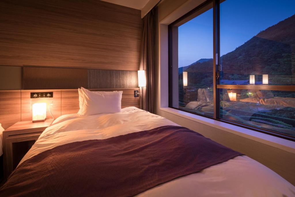 Postel nebo postele na pokoji v ubytování Hotel Koyokan
