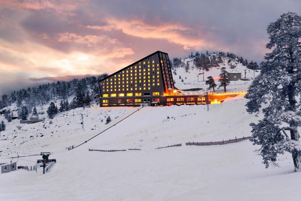 a building on top of a snow covered mountain at Kaya Palazzo Ski & Mountain Resort in Kartalkaya