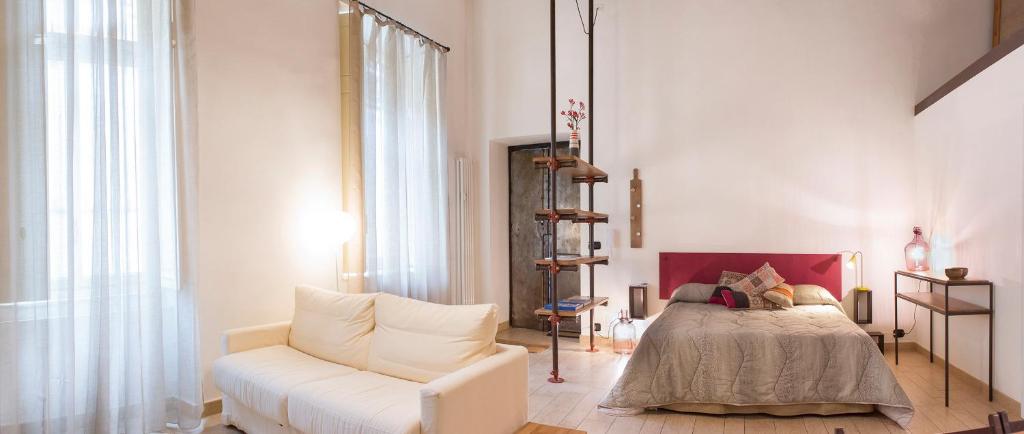 un soggiorno con letto e divano bianco di Il salottino in via Carlo Alberto a Torino