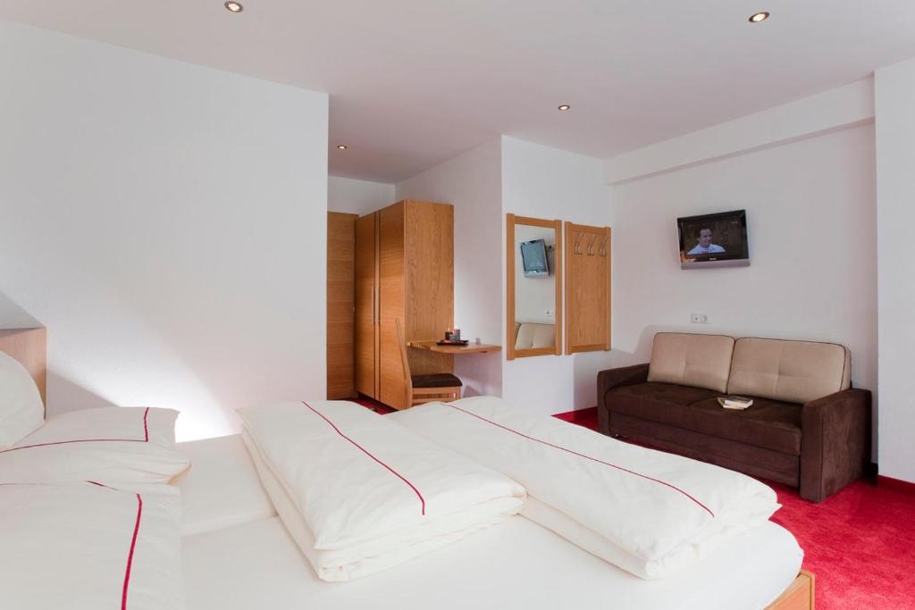 Postel nebo postele na pokoji v ubytování Hotel Garni Auriga