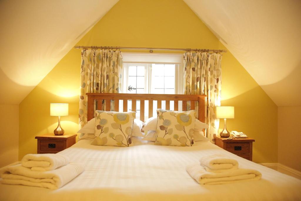 a bedroom with a large bed with towels on it at B+B York in York
