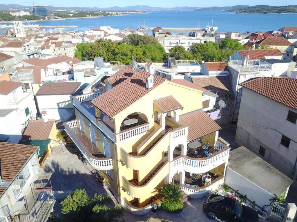 eine Luftansicht einer Stadt mit gelbem Gebäude in der Unterkunft Apartments Visnja in Vodice