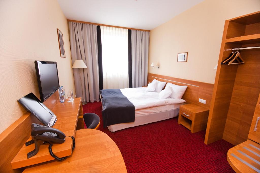 Postel nebo postele na pokoji v ubytování Hotel Malinowski Business