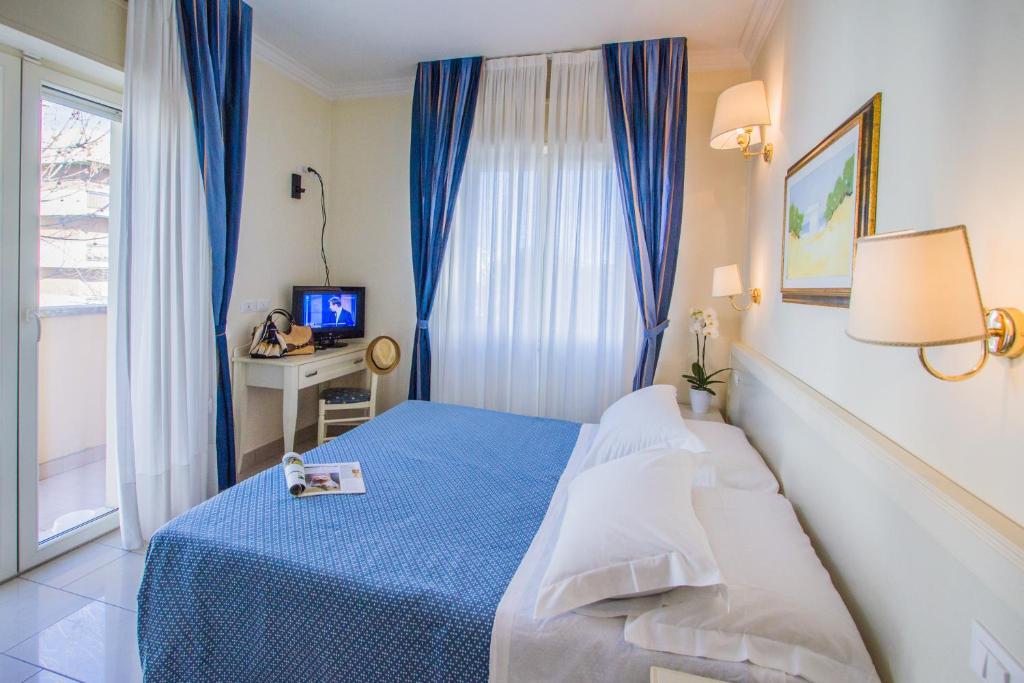 Postel nebo postele na pokoji v ubytování Hotel Nelson