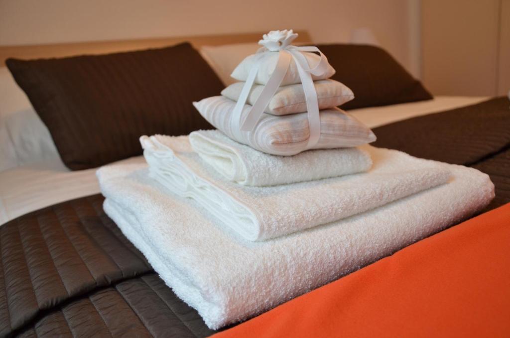 a pile of towels sitting on top of a bed at Holiday in Rome in Rome