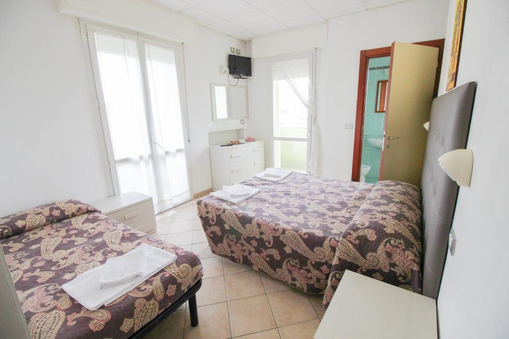 Łóżko lub łóżka w pokoju w obiekcie Residence Eurogarden