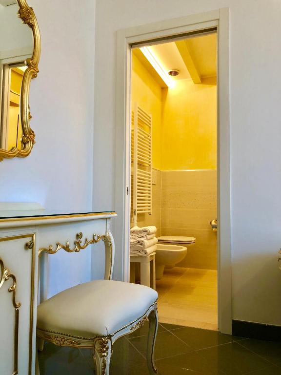 a bathroom with a chair and a mirror at Hotel Marte in Venice