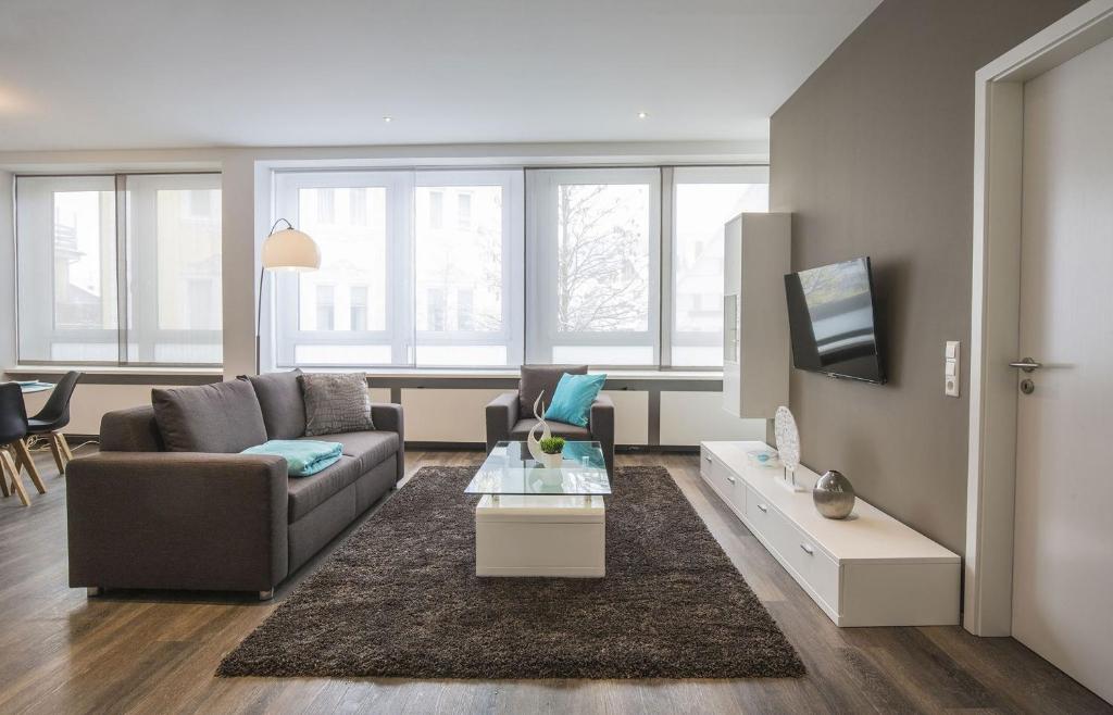 a living room with a couch and a tv at Apartments by Intermezzo in Albstadt