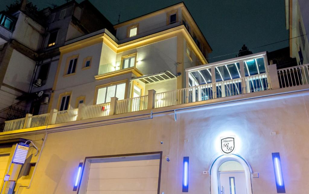 a large white building with a balcony on top of it at Buono B&B in Naples
