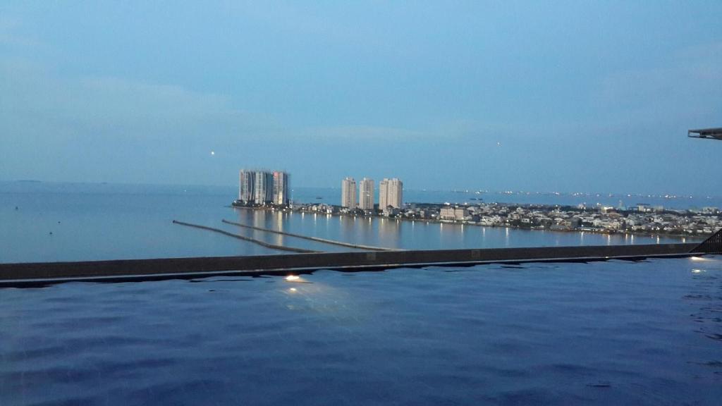 a large body of water with a city in the background at Robert's Condominium in Jakarta
