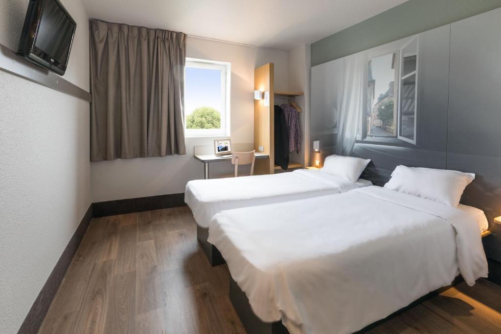 Postel nebo postele na pokoji v ubytování B&B HOTEL Lorient Caudan