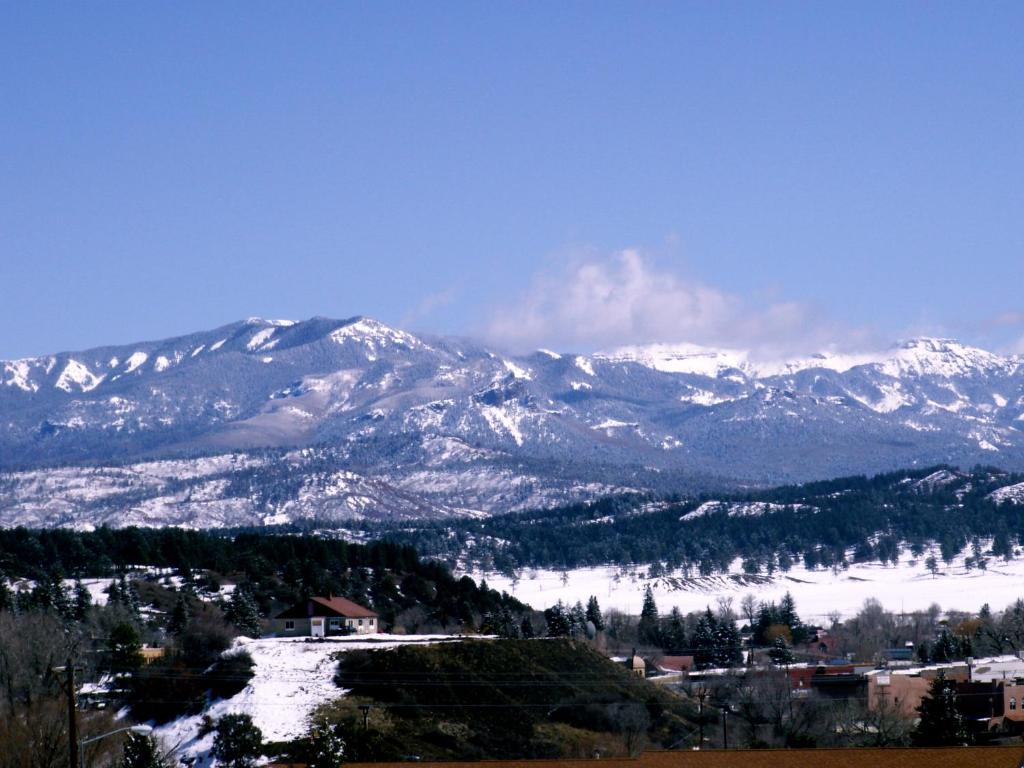 a snow covered mountain range with a town in the foreground at Healing Waters Resort and Spa in Pagosa Springs