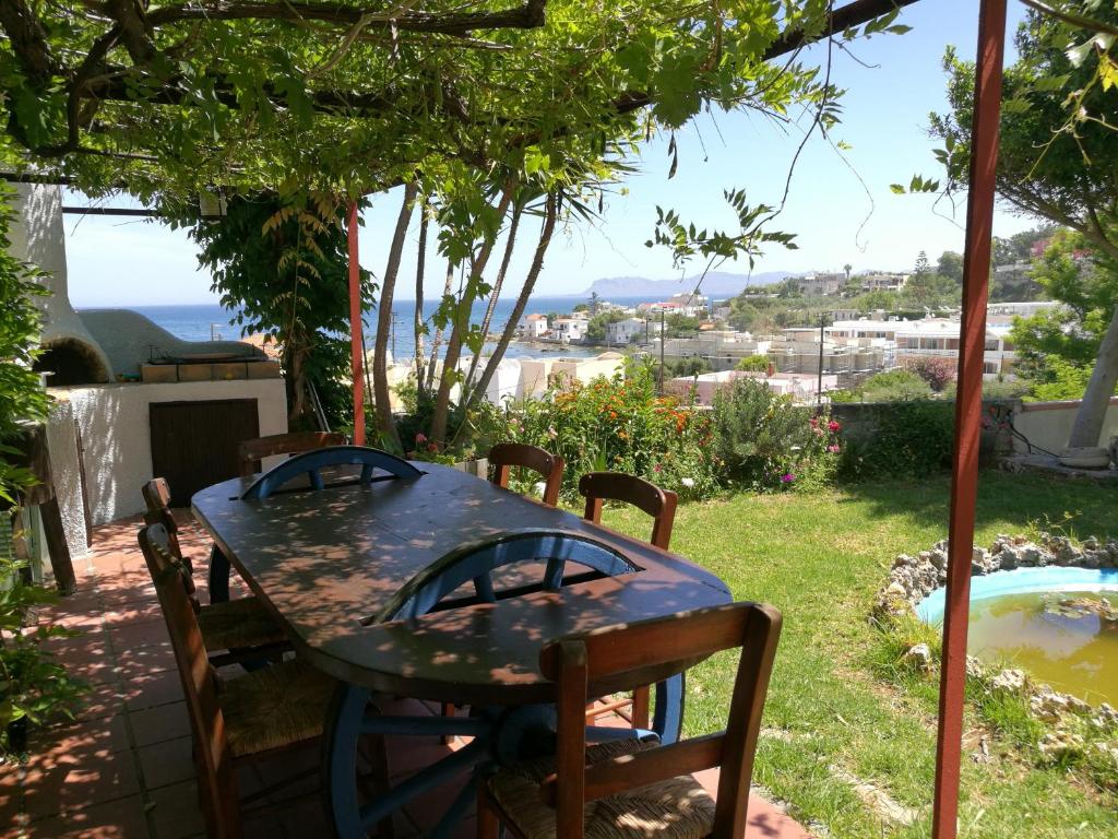 a table and chairs in a yard with a view at Chania Sea View Summer House in Kalamaki Chanion