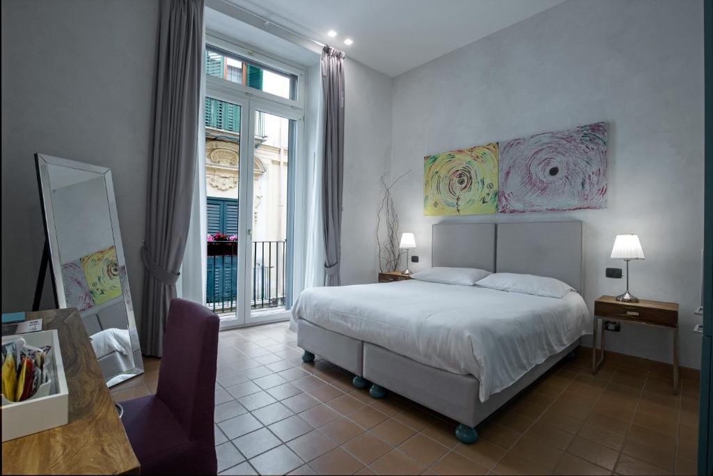 a bedroom with a bed and a large window at B&B Luxury Scacciaventi in Cava deʼ Tirreni