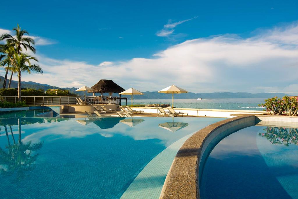 a swimming pool with a view of the beach at Sunset Plaza Beach Resort Puerto Vallarta All Inclusive in Puerto Vallarta