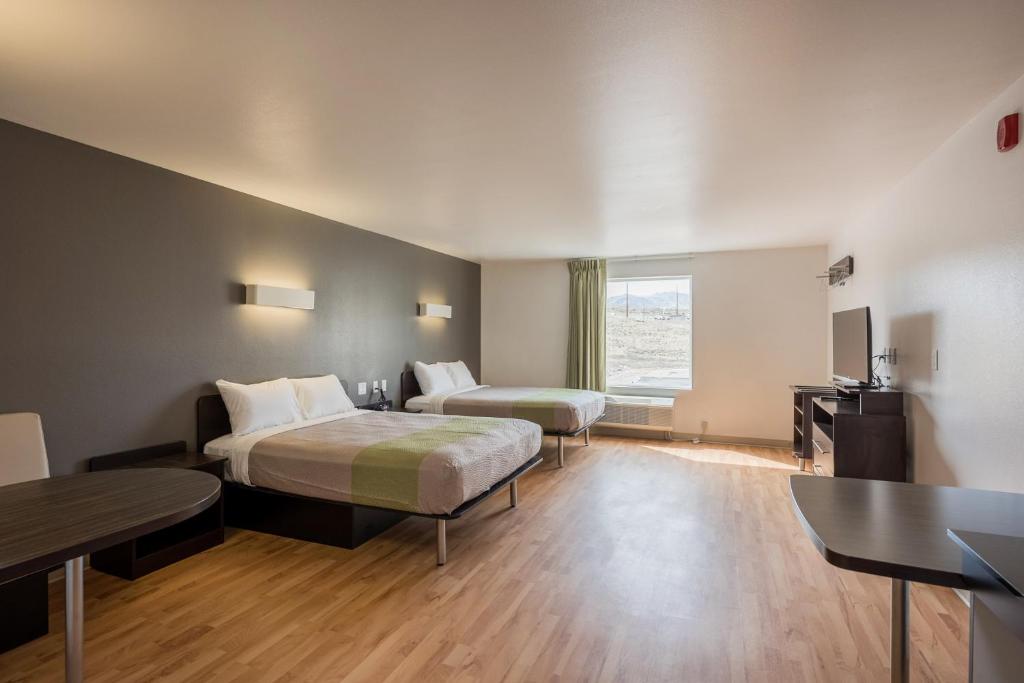 a hotel room with two beds and a television at Studio 6-Mccarran, NV - Sparks - Tahoe - Reno Industrial Center in Clark