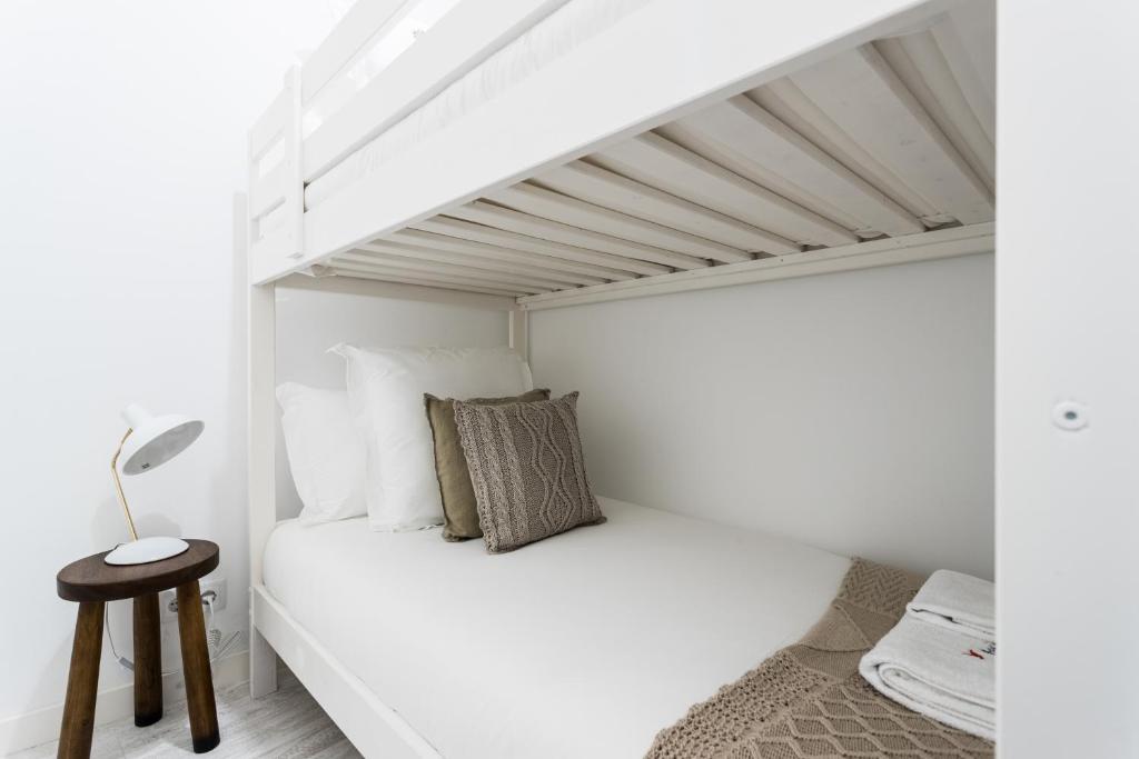 Postel nebo postele na pokoji v ubytování FLH Graça Cozy Flat
