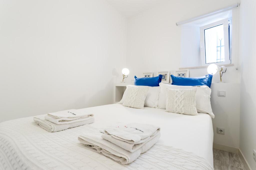 Postel nebo postele na pokoji v ubytování FLH Graça Cozy Flat