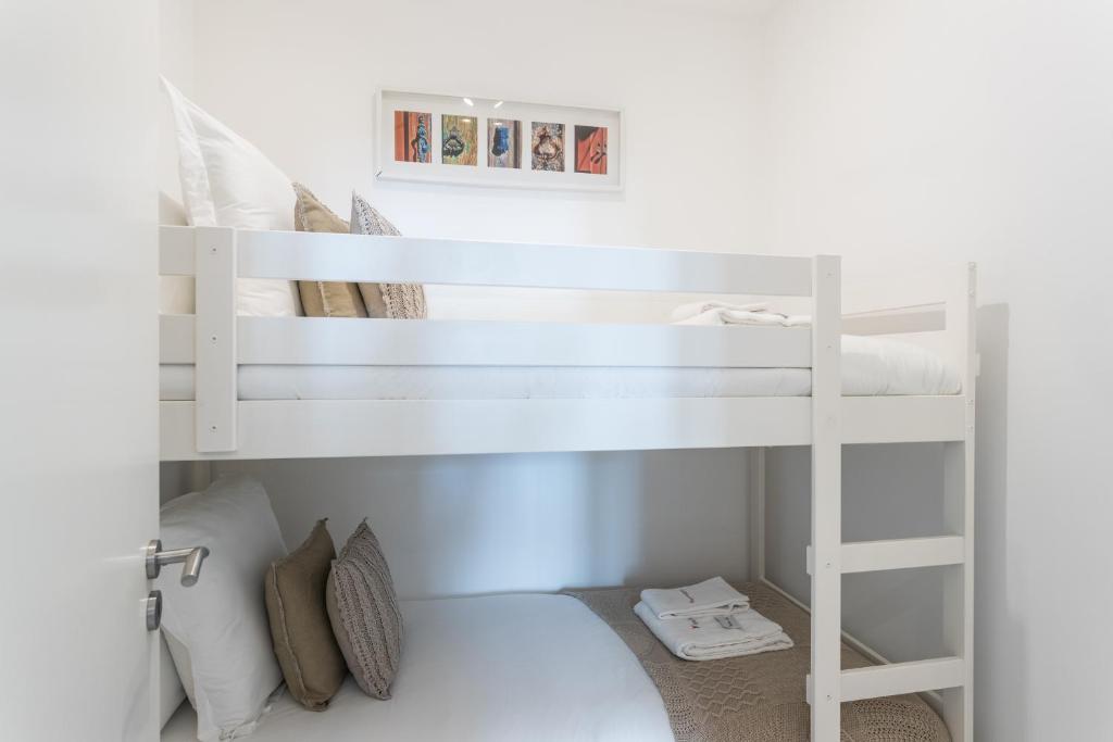 Postel nebo postele na pokoji v ubytování FLH Graça Cozy Flat