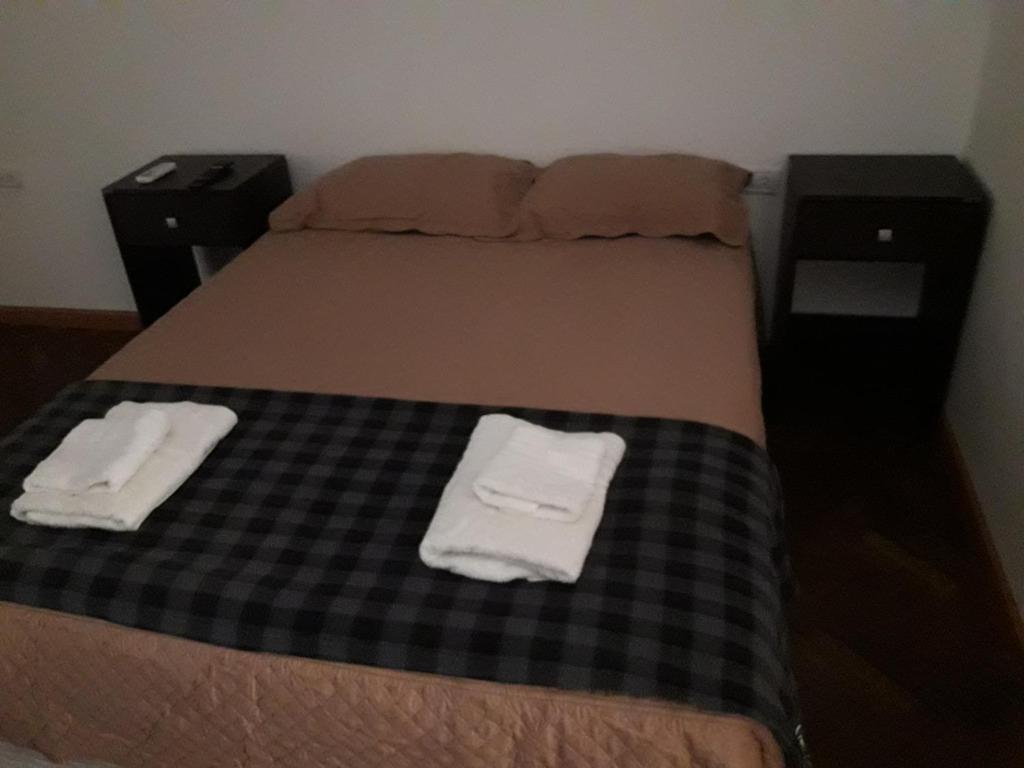 a bedroom with a bed with two towels on it at Departamento Maipú in Paraná