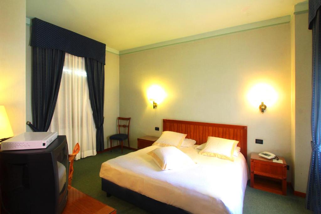 Postel nebo postele na pokoji v ubytování Hotel De Paris