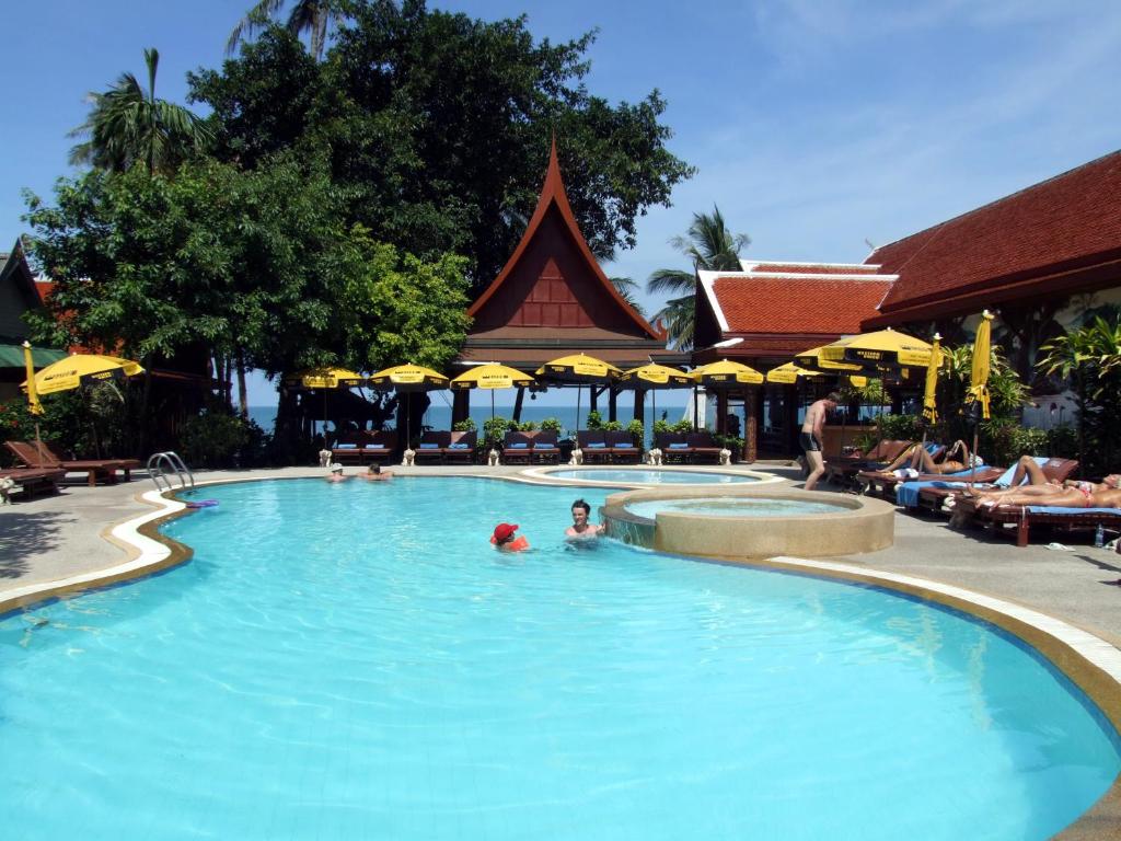 a pool at a resort with people in it at Bill Resort in Lamai