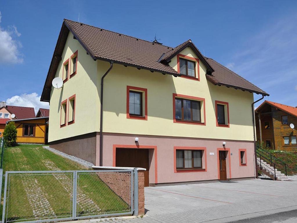 a large house with a fence in front of it at Villa Frymburk in Frymburk