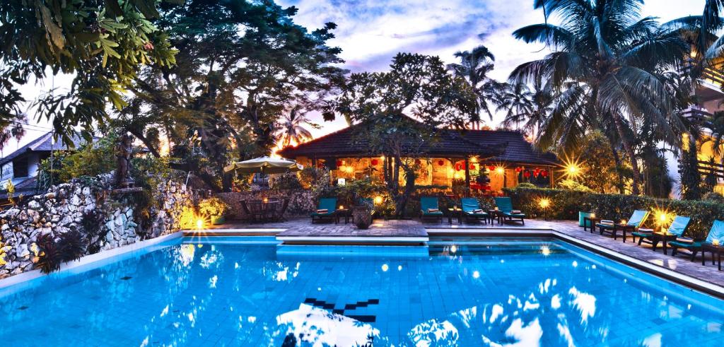 een zwembad voor een huis bij Hotel Grand Kumala Bali in Legian