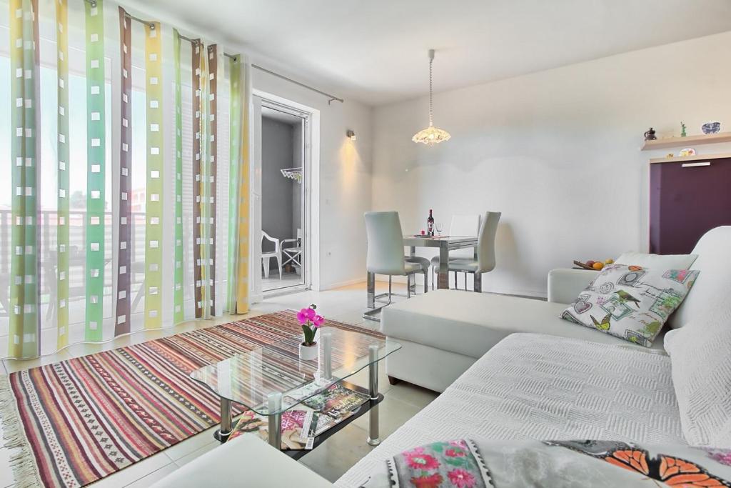a living room with a couch and a table at SUMMERTIME house with apartment in Umag