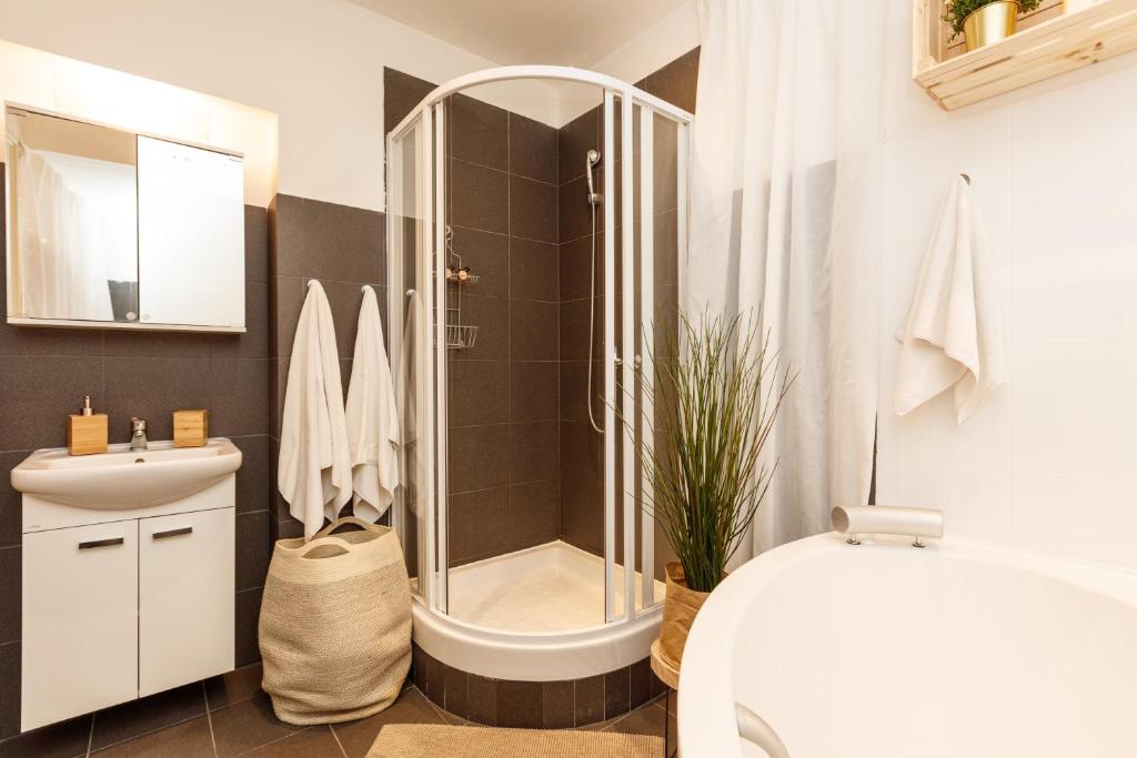 a bathroom with a shower and a toilet and a sink at Chill apartments in Prague