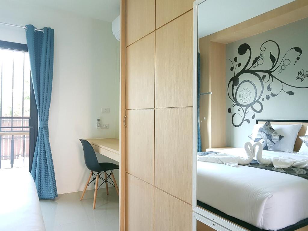 Postel nebo postele na pokoji v ubytování Sirimunta Hotel Chiang Rai Suite & Residence