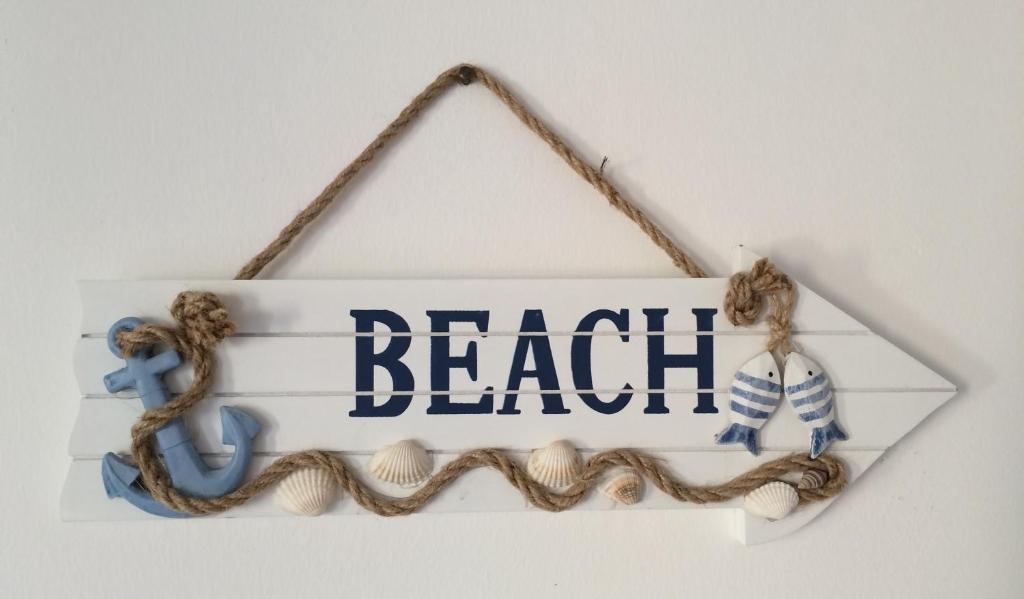 a beach sign hanging on a wall at Casa Liliana in Levanto