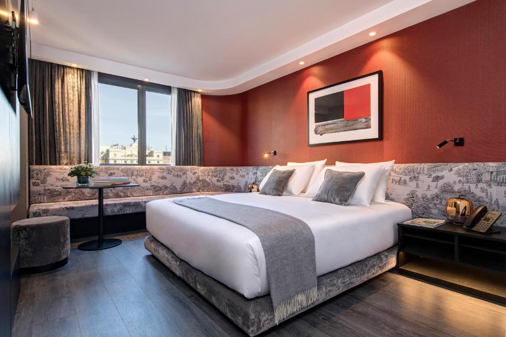 a hotel room with a large bed and a window at The Pavilions Madrid Hotel in Madrid