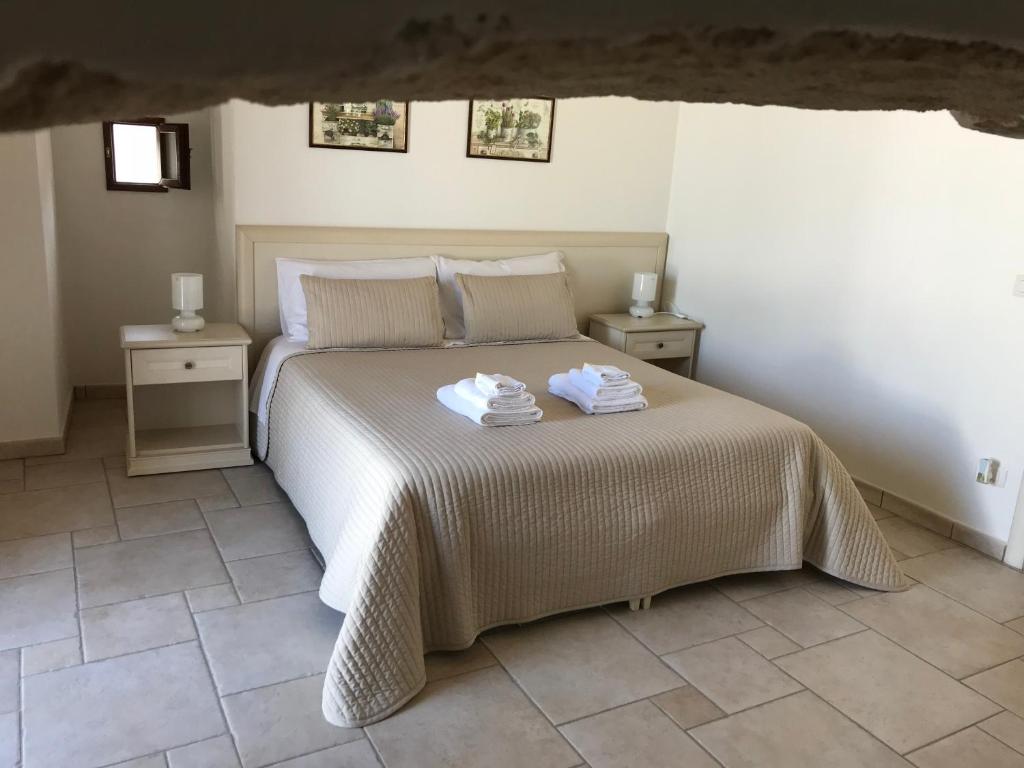 a bedroom with a bed with two towels on it at Il Terrazzino in Laterza