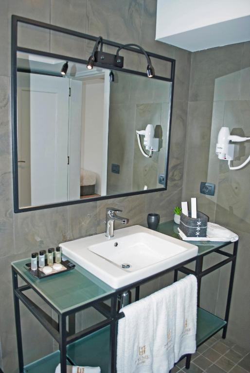 a bathroom with a sink and a mirror at Prime Hotel in Tirana