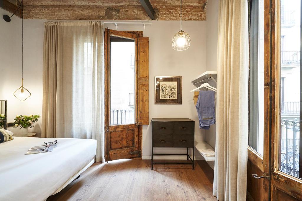 Posteľ alebo postele v izbe v ubytovaní AinB Gothic-Jaume I Apartments
