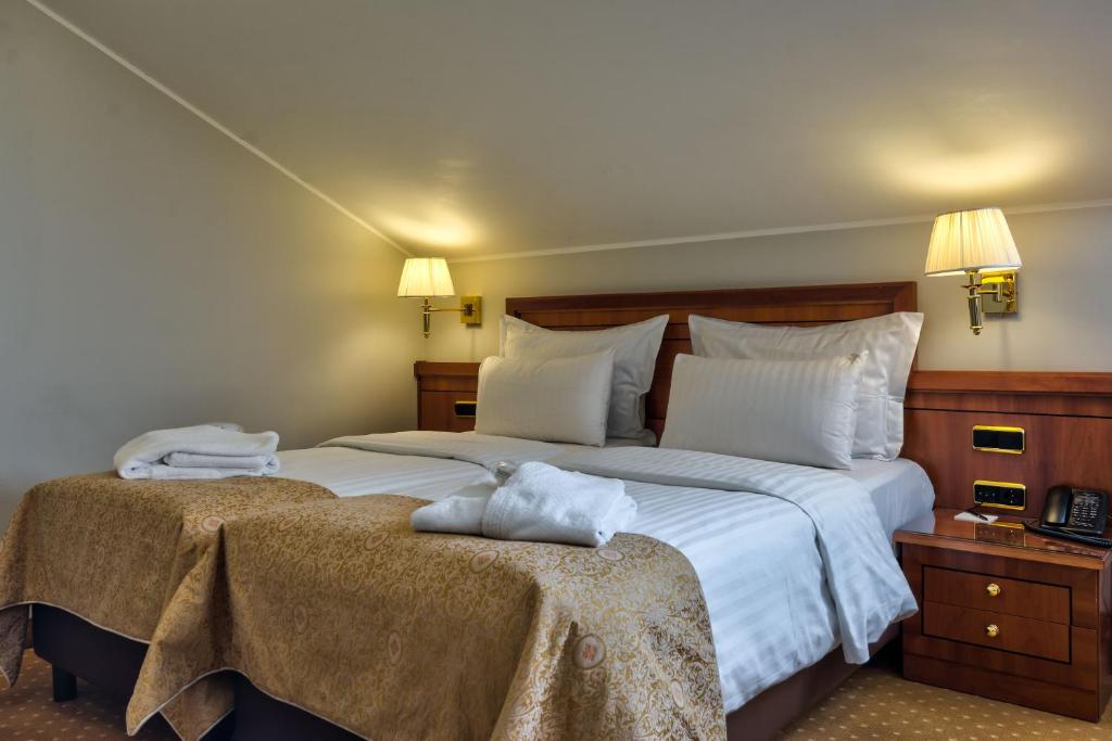 Postel nebo postele na pokoji v ubytování My City Hotel