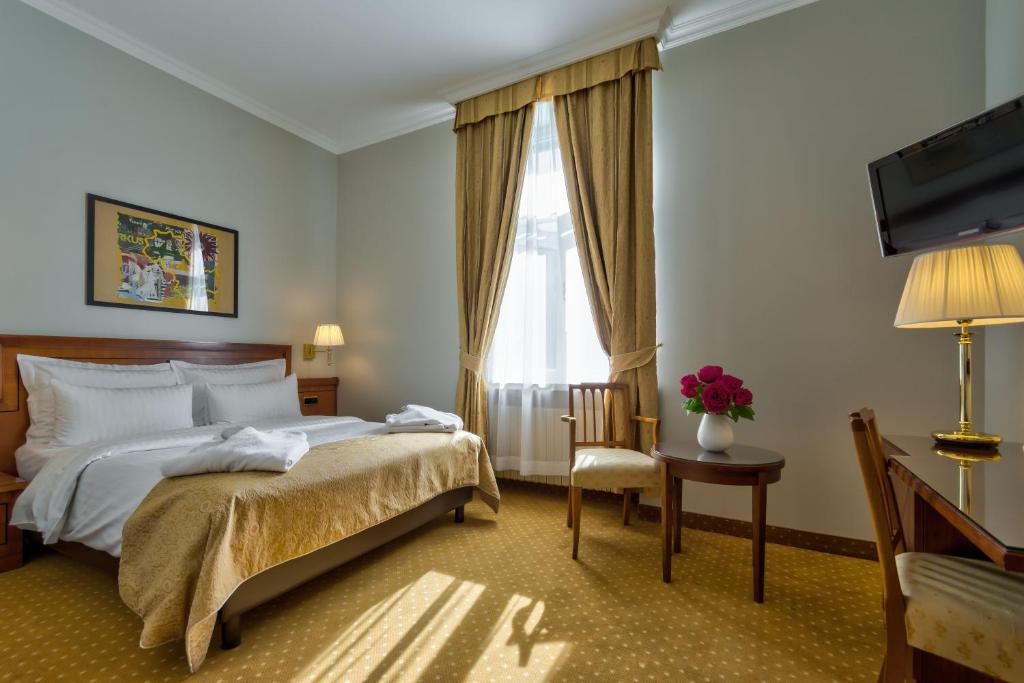 Postel nebo postele na pokoji v ubytování My City Hotel