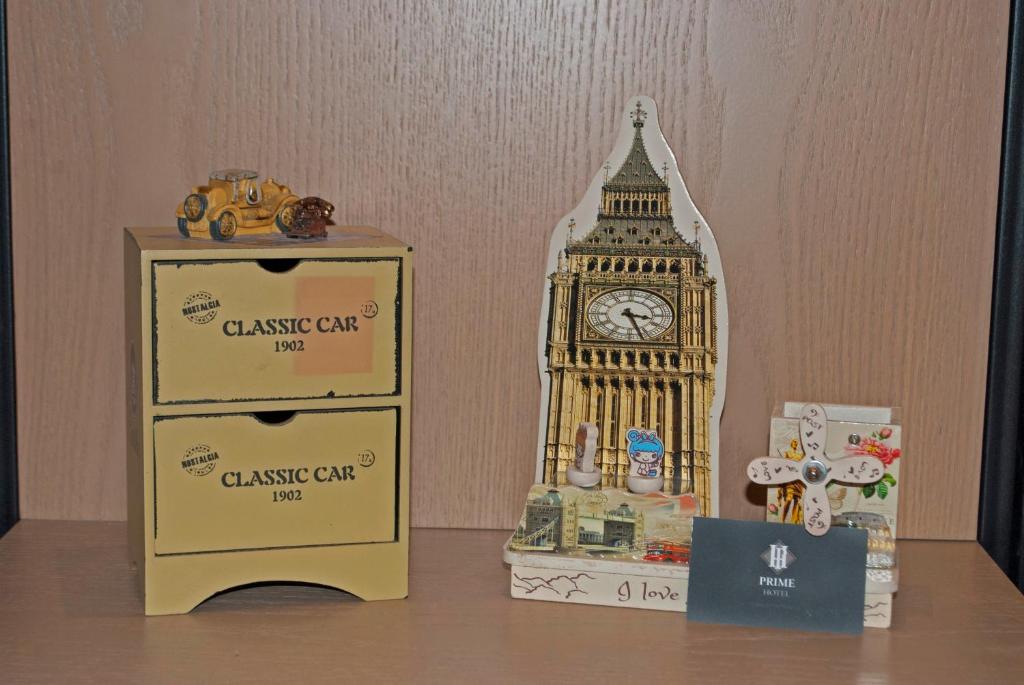 a clock tower and a box on a table at Prime Hotel in Tirana