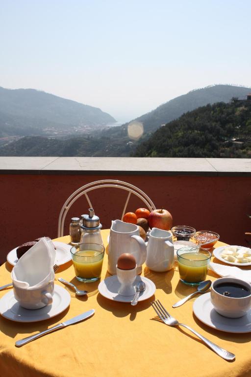 a table with plates and cups and utensils on it at L'Antico Borgo B&B in Levanto