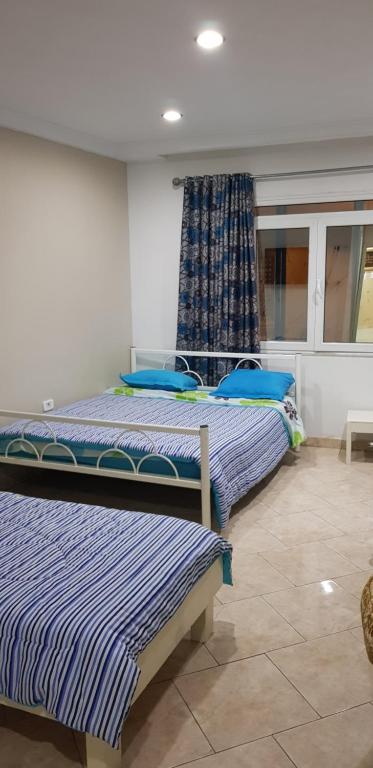Una cama o camas en una habitación de Hotel Afef