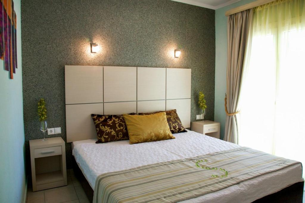 Postel nebo postele na pokoji v ubytování Kaplanis House
